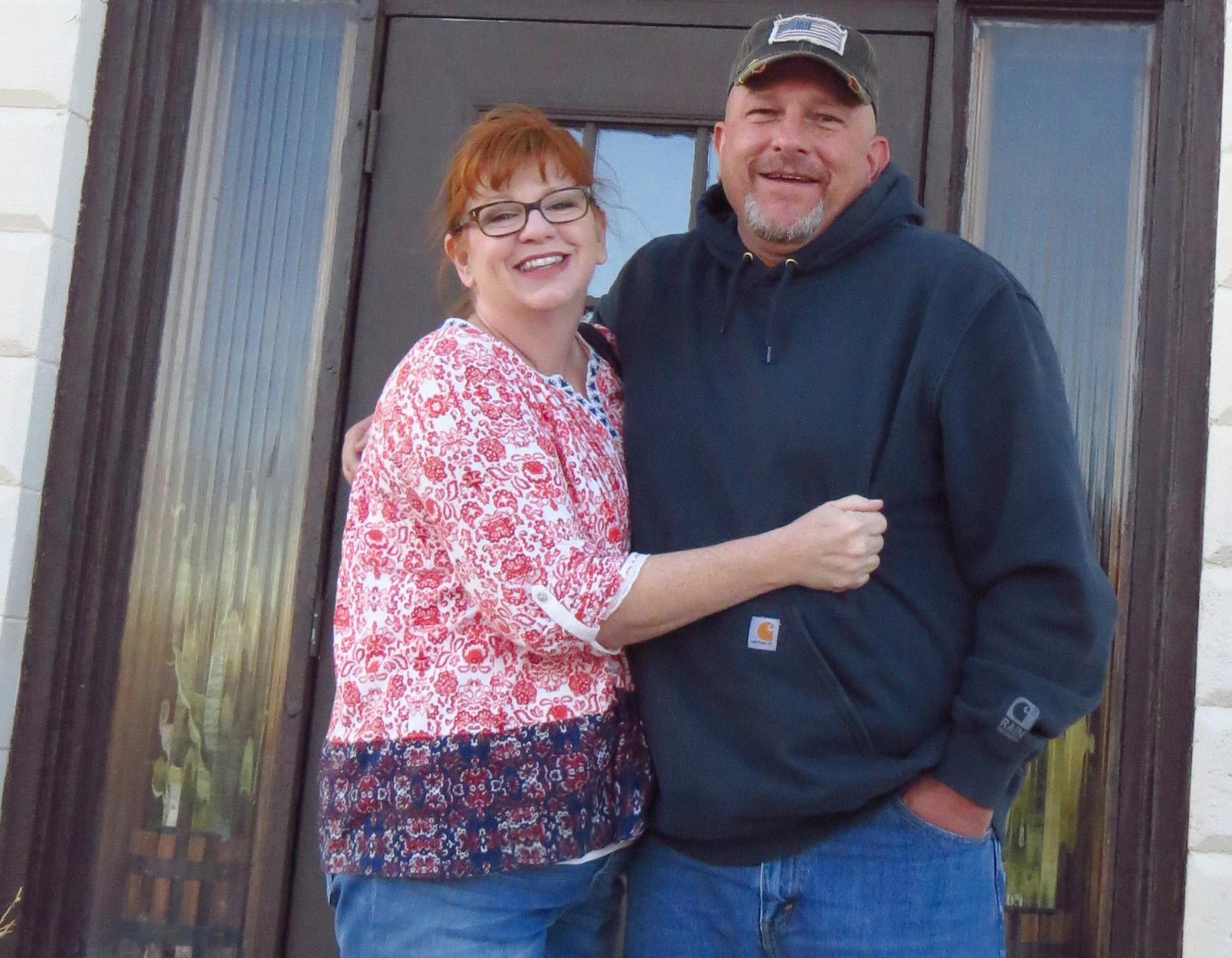 Contributed Photo<strong>Karyl and Mike Hutchinson stand outside of their home in Chappell, Neb.</strong>